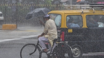 People going through the heavy rain at CSMT, in Mumbai. People going through the heavy rain at CSMT, in Mumbai.
