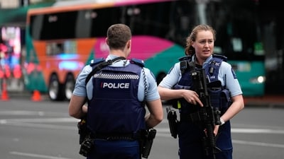 Armed New Zealand police officers stand outside a hotel housing a team from the FIFA Women's World Cup in the central business district following a shooting in Auckland, New Zealand. (AP) Armed New Zealand police officers stand outside a hotel housing a team from the FIFA Women's World Cup in the central business district following a shooting in Auckland, New Zealand. (AP)