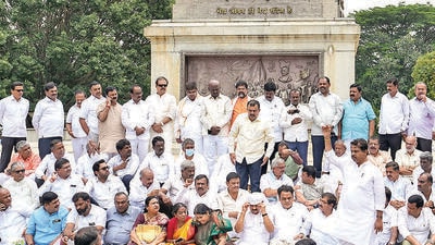 BJP MLAs stage a protest near the statue of Mahatma Gandhi against the suspension of 10 party MLAs in Bengaluru on Thursday. (PTI)