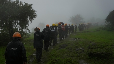Rescuers walk towards the site of a landslide in Raigad district, western Maharashtra state, India, Thursday, July 20, 2023. (AP)