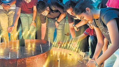 Students during a candlelight vigil, against the Manipur violence, at Chanakya National Law University in Patna on Thursday. (Santosh Kumar/HT) Students during a candlelight vigil, against the Manipur violence, at Chanakya National Law University in Patna on Thursday. (Santosh Kumar/HT)