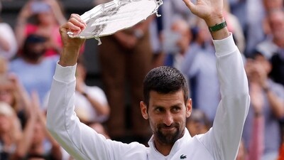 Serbia's Novak Djokovic with the runners-up trophy after losing to Spain's Carlos Alcaraz in the men's final (REUTERS)