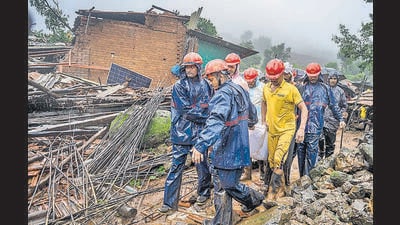 Volunteers from Thane, Navi Mumbai and Raigad districts had arrived earlier to help in the rescue operation. “Ground zero presented a devastating sight – the mudslide had buried the entire village. Some families were wiped out completely. We had to remove the debris manually, till teams from NDRF and Thane Disaster Relief Force arrived. The rain made our job difficult,” said Mohammed Hanif Hussain Karjikar, from Aapda Mitra, a volunteer organisation from Khopoli. He added, a group of 50 to 60 workers landed up at the site soon. (Satish Bate/HT PHOTO)