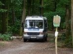 A police vehicle passes to search close to the forest after police warned the public that a suspected lioness was on the loose, in Zehlendorf, Berlin.