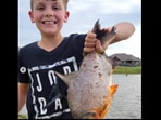 Young angler in the US catches fish with human-like teeth. Young angler in the US catches fish with human-like teeth.