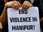 A protester holds a placard during a protest against the ongoing ethnic violence in Manipur state, in New Delhi on Friday. 