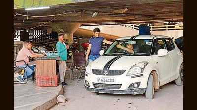 A visitor paying parking fee at the multi-level parking at MC Zone A in Ludhiana on Friday. (Manish/HT)