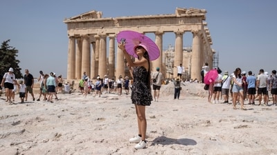 A woman takes a selfie in front of Parthenon temple atop of the ancient Acropolis hill during a heat wave in Athens, Greece on Friday. (AP) A woman takes a selfie in front of Parthenon temple atop of the ancient Acropolis hill during a heat wave in Athens, Greece on Friday. (AP)