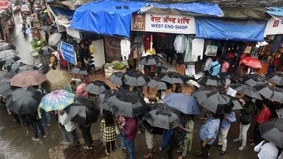 Pedestrians hold umbrellas as rain falls in Mumbai on Friday. The Brihanmumbai Electric Supply and Transport (BEST) Ltd diverted buses on more than 12 routes due to waterlogging in Sion in the afternoon. (Bloomberg) Pedestrians hold umbrellas as rain falls in Mumbai on Friday. The Brihanmumbai Electric Supply and Transport (BEST) Ltd diverted buses on more than 12 routes due to waterlogging in Sion in the afternoon. (Bloomberg)