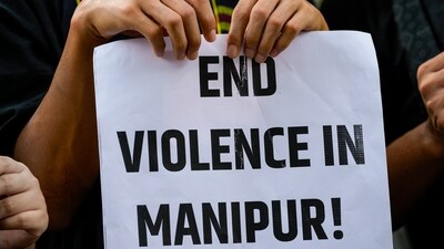 A protester holds a placard during a protest against the ongoing ethnic violence in Manipur state, in New Delhi on Friday. (PTI) A protester holds a placard during a protest against the ongoing ethnic violence in Manipur state, in New Delhi on Friday. (PTI)