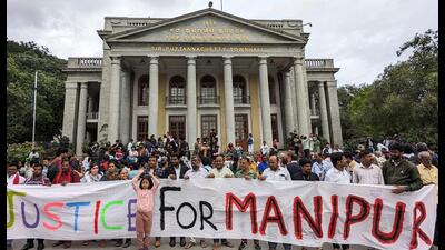 People gather outside Town Hall to protest against the alleged sexual assault of two tribal women in Manipur, in Bengaluru on Friday. (Reuters) People gather outside Town Hall to protest against the alleged sexual assault of two tribal women in Manipur, in Bengaluru on Friday. (Reuters)