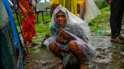 A woman whose family members are trapped under rubble wails after a landslide washed away houses in Raigad district in Maharashtra. (AP) A woman whose family members are trapped under rubble wails after a landslide washed away houses in Raigad district in Maharashtra. (AP)