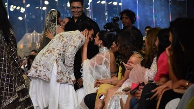 Karan Johar smiles as Ranveer Singh bends down to give Deepika Padukone a kiss. Deepika was in a white sheer saree and a backless halter blouse. Karan Johar smiles as Ranveer Singh bends down to give Deepika Padukone a kiss. Deepika was in a white sheer saree and a backless halter blouse. 