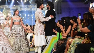 Ranveer Singh also shared a hug with his Gunday co-star and friend Arjun Kapoor in between his ramp walk. Arjun wore a statement black bandhgala and white pants for the event. Ranveer Singh also shared a hug with his Gunday co-star and friend Arjun Kapoor in between his ramp walk. Arjun wore a statement black bandhgala and white pants for the event. 