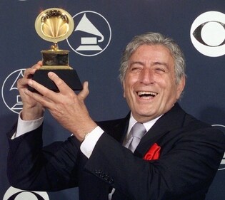 Singer Tony Bennett holds his Grammy Award February 25, 1998, in New York. Bennett was awards the Best Traditional Pop Vocal Performance for 'Tony Bennett on Holiday' (Photo by MATT CAMPBELL / AFP) (AFP) Singer Tony Bennett holds his Grammy Award February 25, 1998, in New York. Bennett was awards the Best Traditional Pop Vocal Performance for 'Tony Bennett on Holiday' (Photo by MATT CAMPBELL / AFP) (AFP)