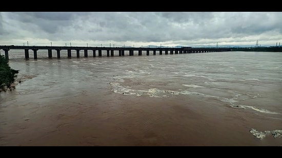 The swollen Godavari river flows in spate after heavy monsoon rainfall, in Bhadrachalam on Friday. (PTI)