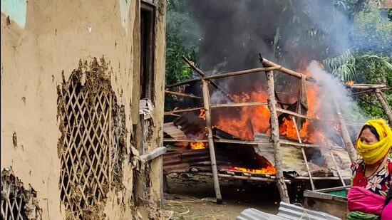 Women burn the house of one of the men accused of parading two women naked in front of a mob, in Manipur, on Friday. (AFP)