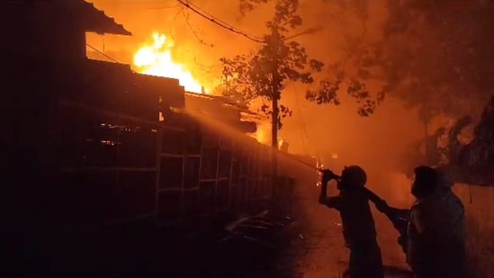 Firefighters attempt to douse a fire that broke out at Mangala Haat in Howrah district, Friday. (PTI)