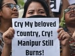 Members of tribal communities and All India Students Association hold placards and shout slogans during protest over sexual violence against women and for peace in the ongoing ethnic violence in Manipur, in New Delhi. 