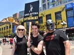 Actors (L-R) Aimee La Joie, Sidney Franklin, Mike Egbert hold a strike sign as they demonstrate during San Diego Comic-Con International in San Diego, California, on July 21, 2023.(AFP)