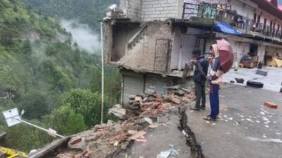 A building collapses while the others remain at risk after cracks emerge on the road at Khaltu Nalah market following heavy rain in Kotkhai of Shimla on Saturday. (HT Photo) A building collapses while the others remain at risk after cracks emerge on the road at Khaltu Nalah market following heavy rain in Kotkhai of Shimla on Saturday. (HT Photo)