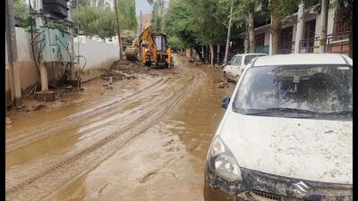 A road covered in mud water due to flash floods triggered by a cloudburst in Leh on Saturday. (ANI) A road covered in mud water due to flash floods triggered by a cloudburst in Leh on Saturday. (ANI)