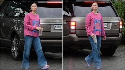 The paparazzi clicked Alia Bhatt outside the Kalina airport in Mumbai today. The star and her Rocky Aur Rani Kii Prem Kahaani co-star Ranveer Singh flew to Kanpur. She slipped into a hot pink sweatshirt featuring a crew neckline, full-length sleeves, a blue patchwork embroidered with 'Team Rocky & Rani', a baggy silhouette, and droopy sleeves. She wore it with dark blue acid-washed flared denim pants featuring a high-rise waist. (HT Photo/Varinder Chawla) The paparazzi clicked Alia Bhatt outside the Kalina airport in Mumbai today. The star and her Rocky Aur Rani Kii Prem Kahaani co-star Ranveer Singh flew to Kanpur. She slipped into a hot pink sweatshirt featuring a crew neckline, full-length sleeves, a blue patchwork embroidered with 'Team Rocky & Rani', a baggy silhouette, and droopy sleeves. She wore it with dark blue acid-washed flared denim pants featuring a high-rise waist. (HT Photo/Varinder Chawla)