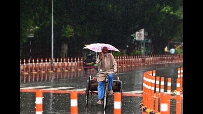 An elderly man caught in the rain in Chandigarh on Saturday. (Ravi Kumar/HT) An elderly man caught in the rain in Chandigarh on Saturday. (Ravi Kumar/HT)