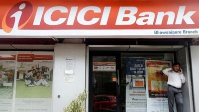 A man speaks on the phone outside an ICICI Bank branch in Kolkata, India. (REUTERS)