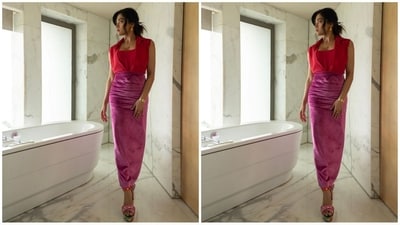 Her ensemble consisted of a red top featuring a collar neckline and a wrap design, which she combined with a long pencil skirt in fuchsia colour, crafted from a rich velvet fabric. (Instagram/@rashmika_mandanna) Her ensemble consisted of a red top featuring a collar neckline and a wrap design, which she combined with a long pencil skirt in fuchsia colour, crafted from a rich velvet fabric. (Instagram/@rashmika_mandanna)