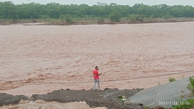 A man stands near the bank of Ghaggar river, which is in spate after heavy rainfall, in Haryana's Panchkula on Saturday.&nbsp; (Sant Arora/ Hindustan Times)