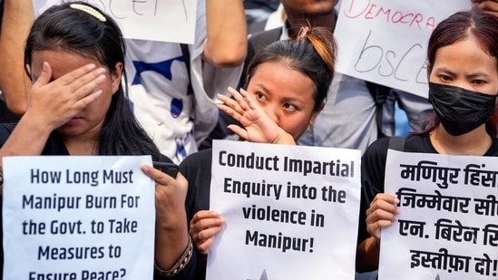 Members of various organisations stage a protest against the ongoing ethnic violence in Manipur in New Delhi on Friday. (PTI)