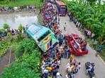 People gather at the site of a bus accident in Jhalkathi, a southern district of Bangladesh