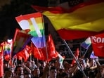 Supporters of Spain's Socialist party wave flags as they await for results on the day of Spain's general election, in Madrid, Spain.