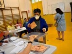 A woman casts her ballot at a polling station in Pamplona, Spain, A woman casts her ballot at a polling station in Pamplona, Spain,