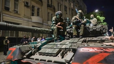 Membes of the Wagner Group military company sit atop of a tank on a street in Rostov-on-Don. (AP) Membes of the Wagner Group military company sit atop of a tank on a street in Rostov-on-Don. (AP)
