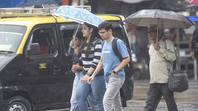 Mumbai, India - July 27, 2022: Pedestrians holding their umbrellas walk in the rain at Sion, in Mumbai, India, on Wednesday, July 27, 2022. (Photo by Pratik Chorge/Hindustan Times) (Pratik Chorge/HT PHOTO)