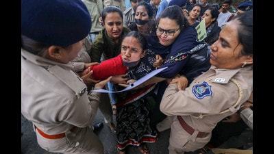 Police personnel detain Congress supporters during their protest against Manipur violence, in Ahmedabad on Sunday. (PTI) Police personnel detain Congress supporters during their protest against Manipur violence, in Ahmedabad on Sunday. (PTI)