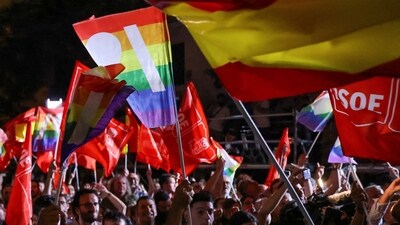 Supporters of Spain's Socialist party wave flags as they await for results on the day of Spain's general election, in Madrid, Spain. (REUTERS)