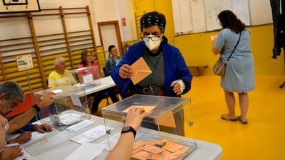A woman casts her ballot at a polling station in Pamplona, Spain, (AP) A woman casts her ballot at a polling station in Pamplona, Spain, (AP)
