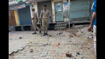 Stones lay bare on a street after they were pelted on Kanwariyas, in Bareilly on Sunday. (PTI) Stones lay bare on a street after they were pelted on Kanwariyas, in Bareilly on Sunday. (PTI)
