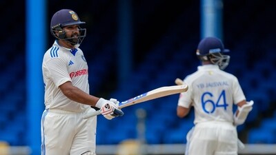 India's captain Rohit Sharma celebrates scoring half a century against West Indies (AP)