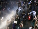 Israeli police use a water cannon to disperse demonstrators blocking a road during a protest against plans by Prime Minister Benjamin Netanyahu's government to overhaul the judicial system, in Jerusalem, Monday. Israeli police use a water cannon to disperse demonstrators blocking a road during a protest against plans by Prime Minister Benjamin Netanyahu's government to overhaul the judicial system, in Jerusalem, Monday.