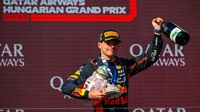 Dutch Formula One driver Max Verstappen of Red Bull Racing celebrates on the podium after winning the Formula One Hungarian Grand Prix auto race, at the Hungaroring racetrack (AP) Dutch Formula One driver Max Verstappen of Red Bull Racing celebrates on the podium after winning the Formula One Hungarian Grand Prix auto race, at the Hungaroring racetrack (AP)