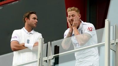 England's Stuart Broad, left and Ben Stokes look out from the players balcony after play was abandoned (AP) England's Stuart Broad, left and Ben Stokes look out from the players balcony after play was abandoned (AP)