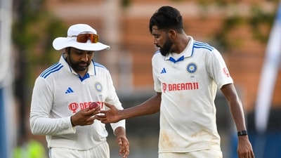 Rohit Sharma (L) gives the ball to Mohammed Siraj (R), of India, during the fourth day of the second Test (AFP) Rohit Sharma (L) gives the ball to Mohammed Siraj (R), of India, during the fourth day of the second Test (AFP)