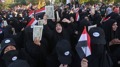 Supporters of Iraq's Hashed al-Shaabi (Popular Mobilisation) group take part in a protest denouncing the burning in Sweden of the Koran, Islam's holy book, in al-Jadiriyah area near Baghdad's Green Zone. (AFP)