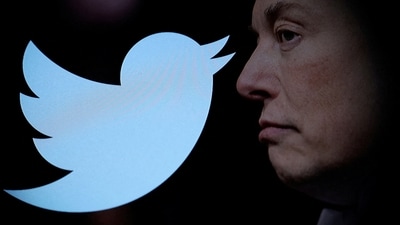 Twitter logo and a photo of Elon Musk are displayed through magnifier in this illustration. (REUTERS)