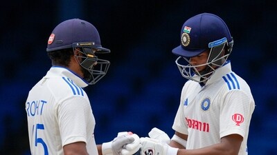 India's captain Rohit Sharma, left, and India's Yashasvi Jaiswal knock gloves during his partnership on day four of their second cricket Test match against West Indies at Queen's Park (AP) India's captain Rohit Sharma, left, and India's Yashasvi Jaiswal knock gloves during his partnership on day four of their second cricket Test match against West Indies at Queen's Park (AP)