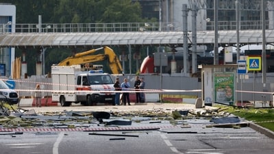 Members of the security services investigate the site of a damaged building following a reported drone attack in Moscow. (Reuters)